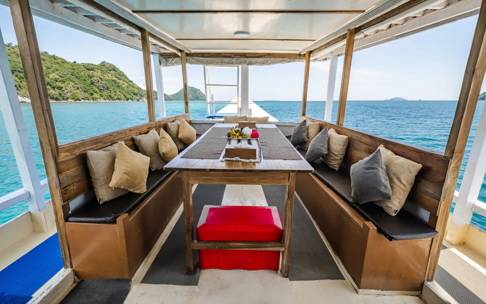 The Arham Jaya II lounge, cushioned sofas around a table with open sea views