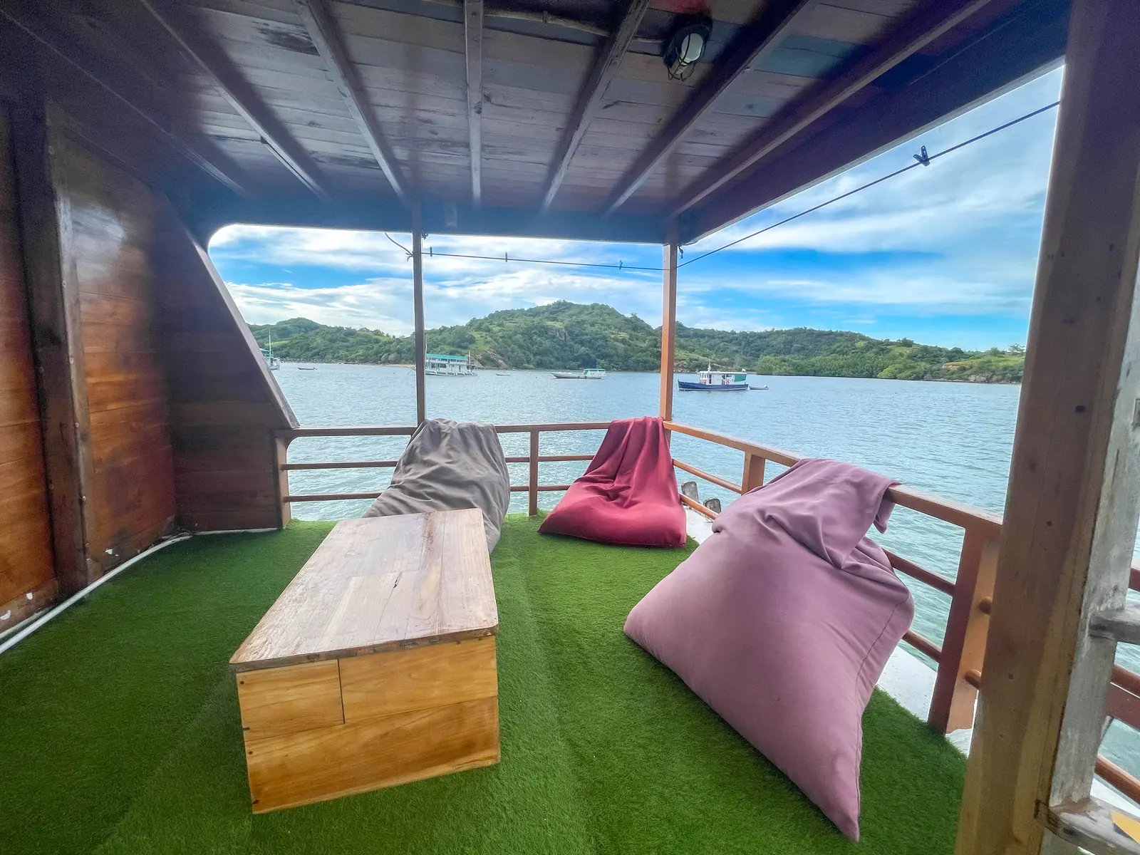 A relaxing corner with bean bags and a wooden table on the Capt Octopus deck