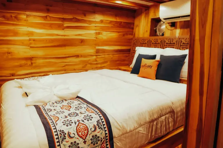 Carnaby II lower-deck Superior Cabin, a double bed and teak-panelled walls