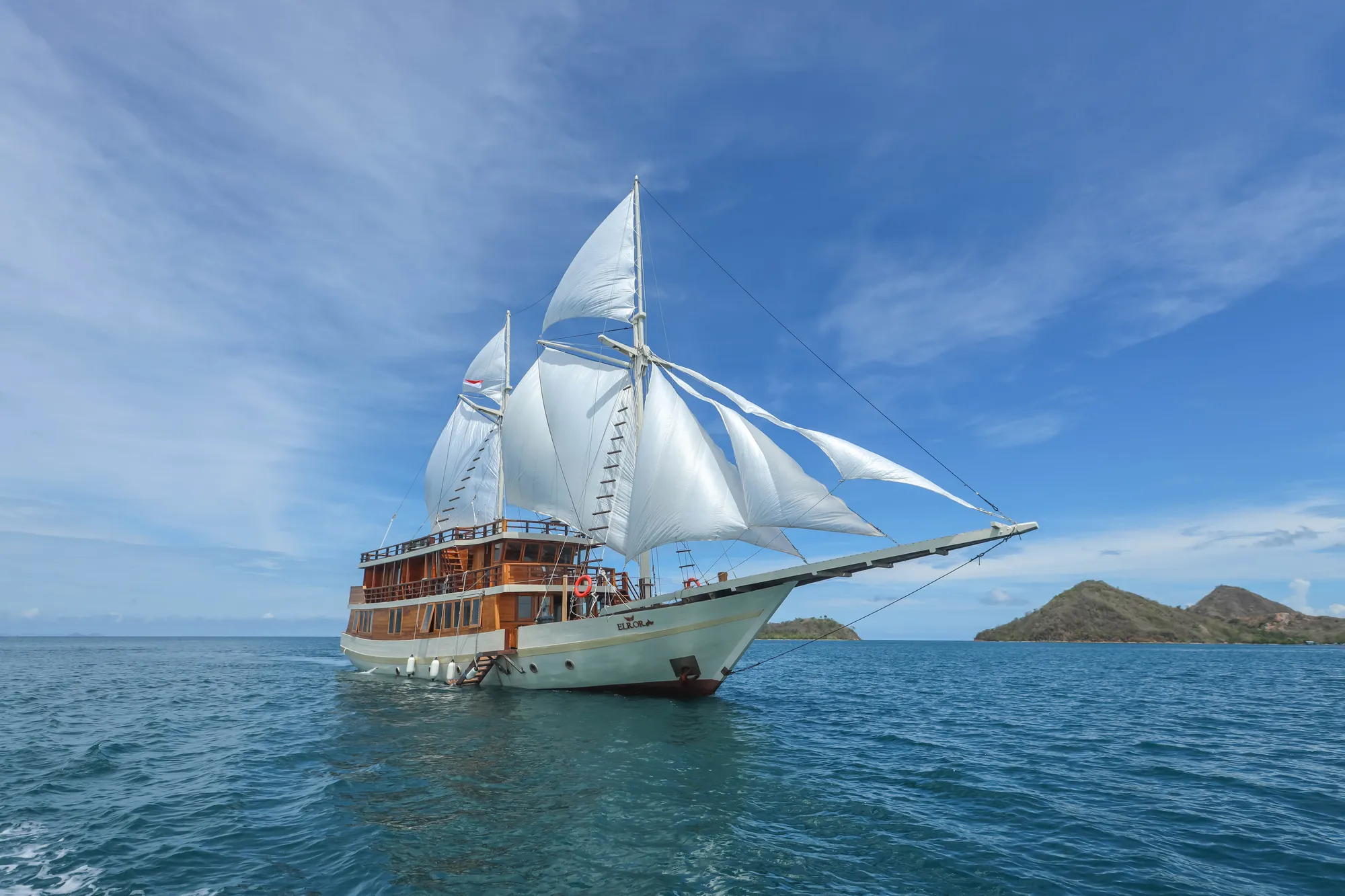 The Elrora phinisi under full sail in the waters off Labuan Bajo