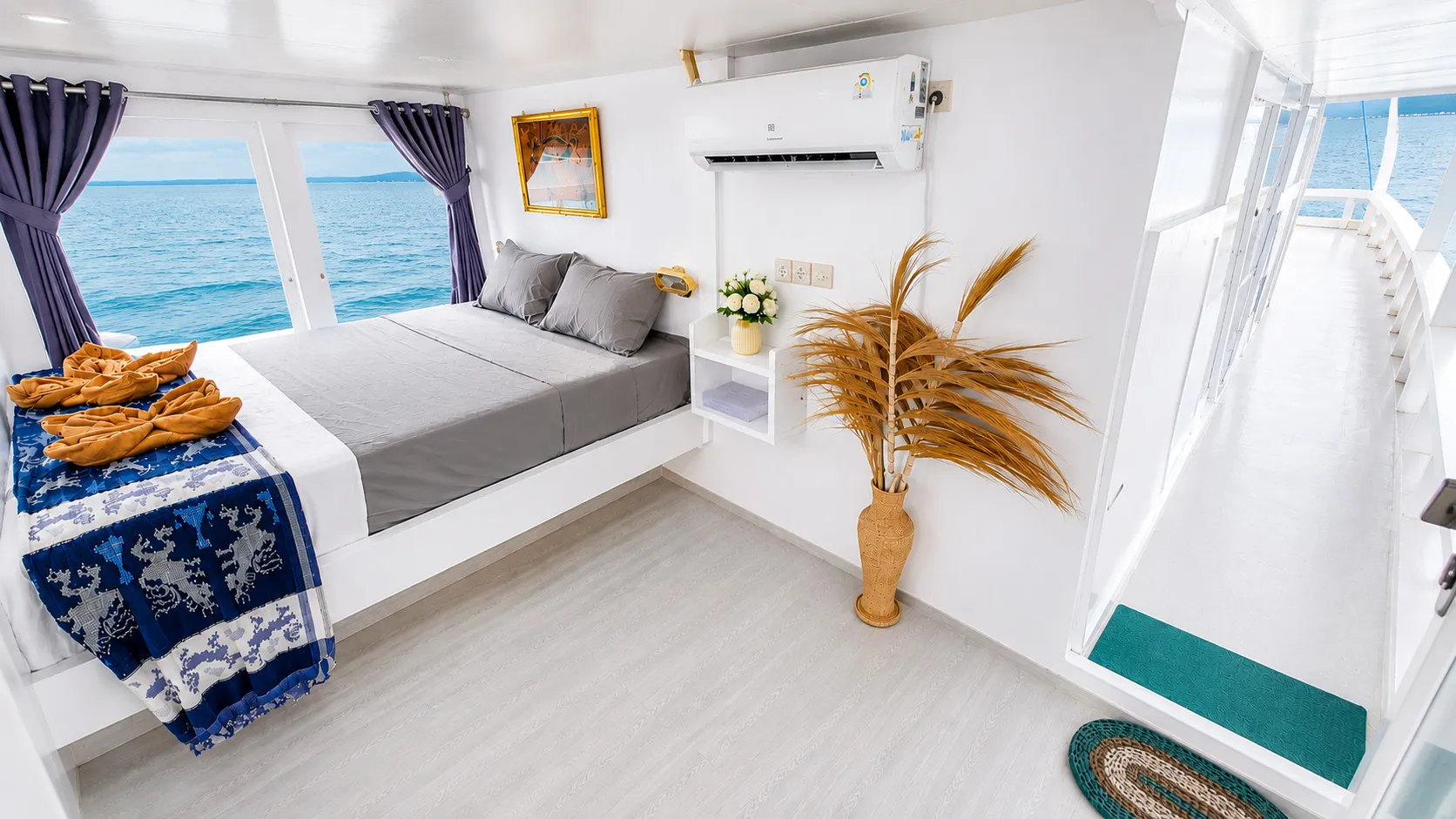 Elyona Master Balcony Cabin, a double bed with sea windows