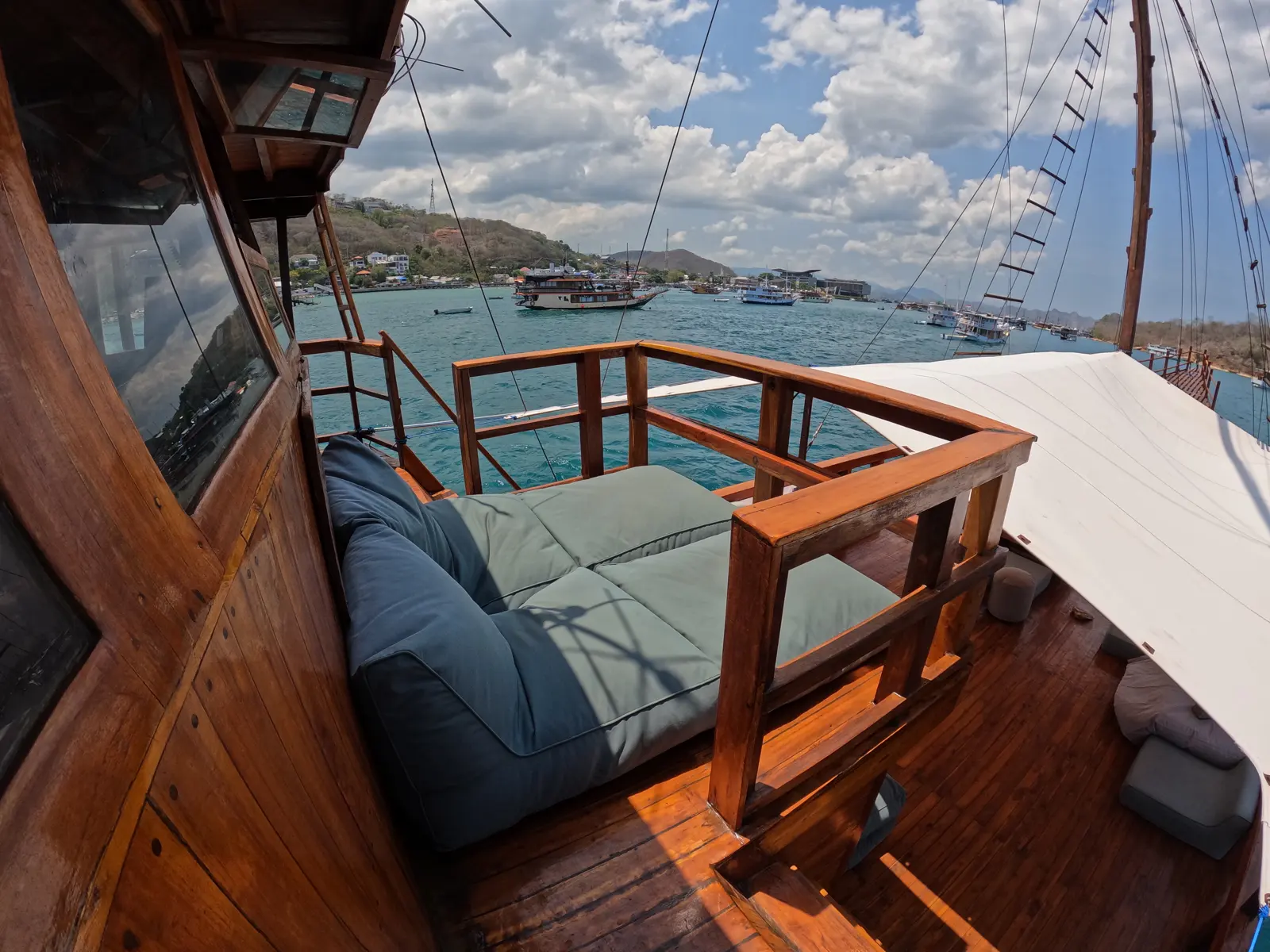 Cushioned day bed on the Gammara upper deck facing the harbour