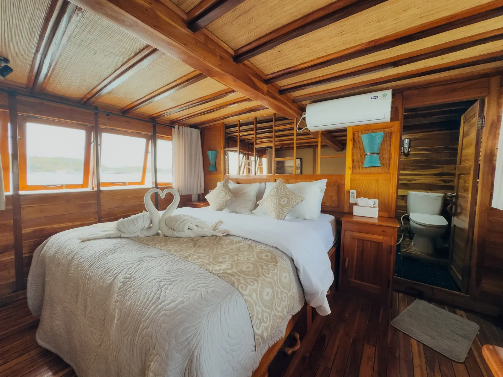 Suite Cabin on Gammara with a king bed, air conditioning and the bathroom beside it