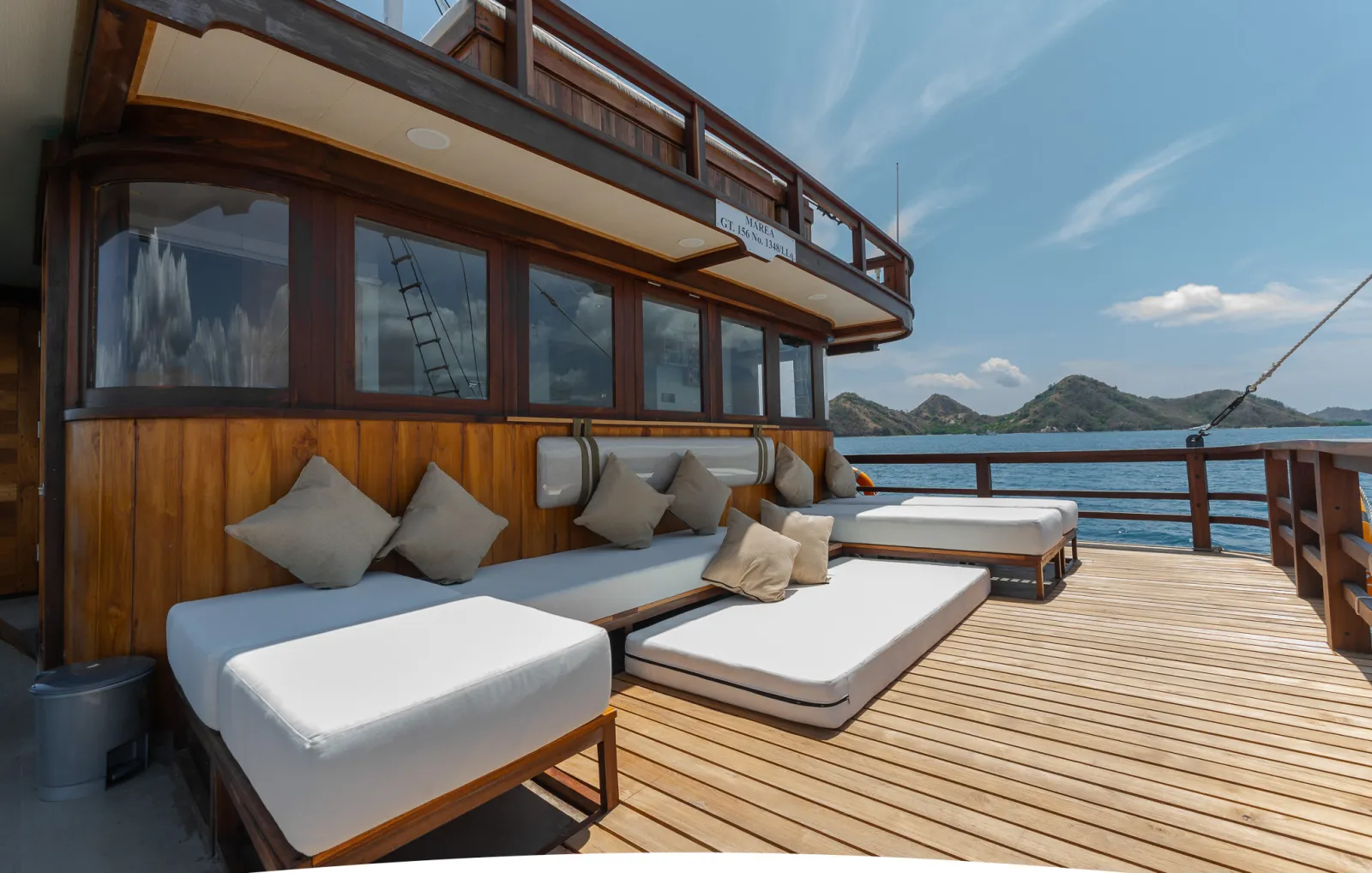 Marea deck lounge with sofas and cushioned daybeds under cover