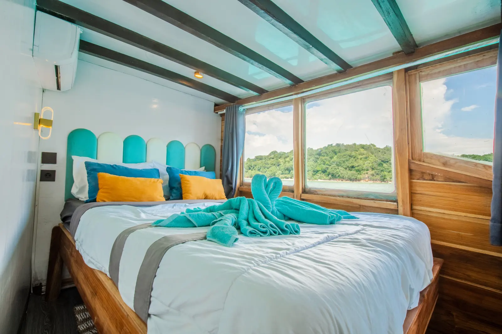 Nusantara Karya Deluxe Ocean, a double bed beside a sea window