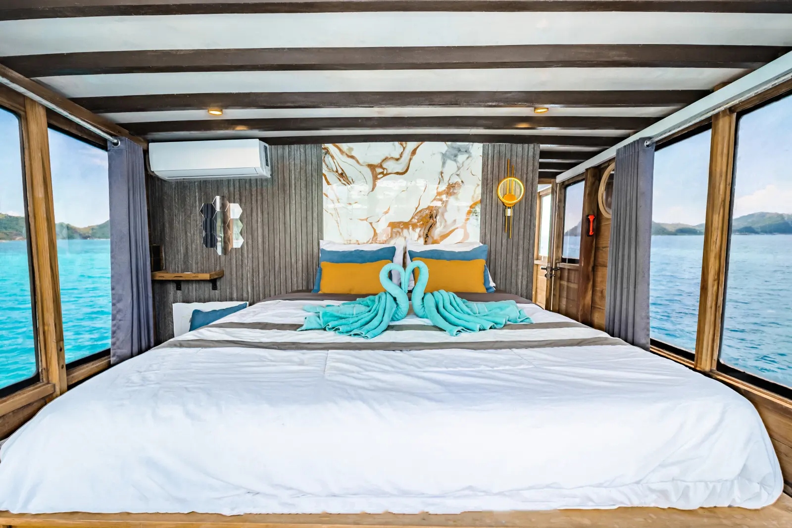 Nusantara Karya Master Cabin Balcony, a double bed with a marble-pattern wall and wide windows