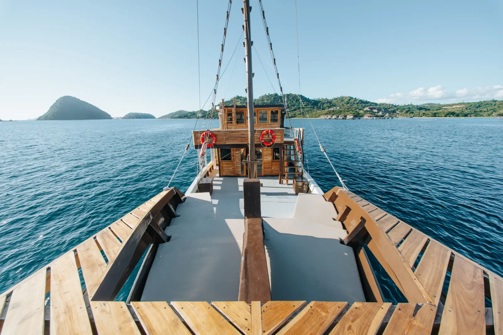 The bow deck of Raja Bintang 03 with a timber floor and benches along both sides