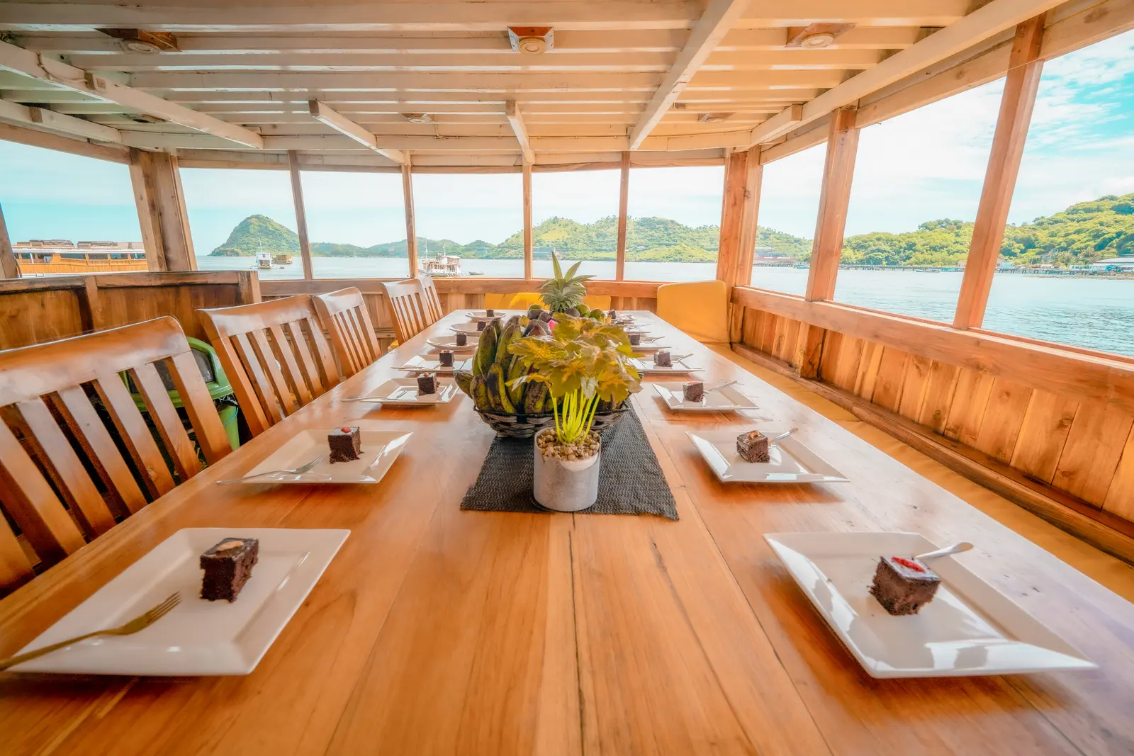 The long NK Jaya dining table surrounded by glass windows looking out to the islands