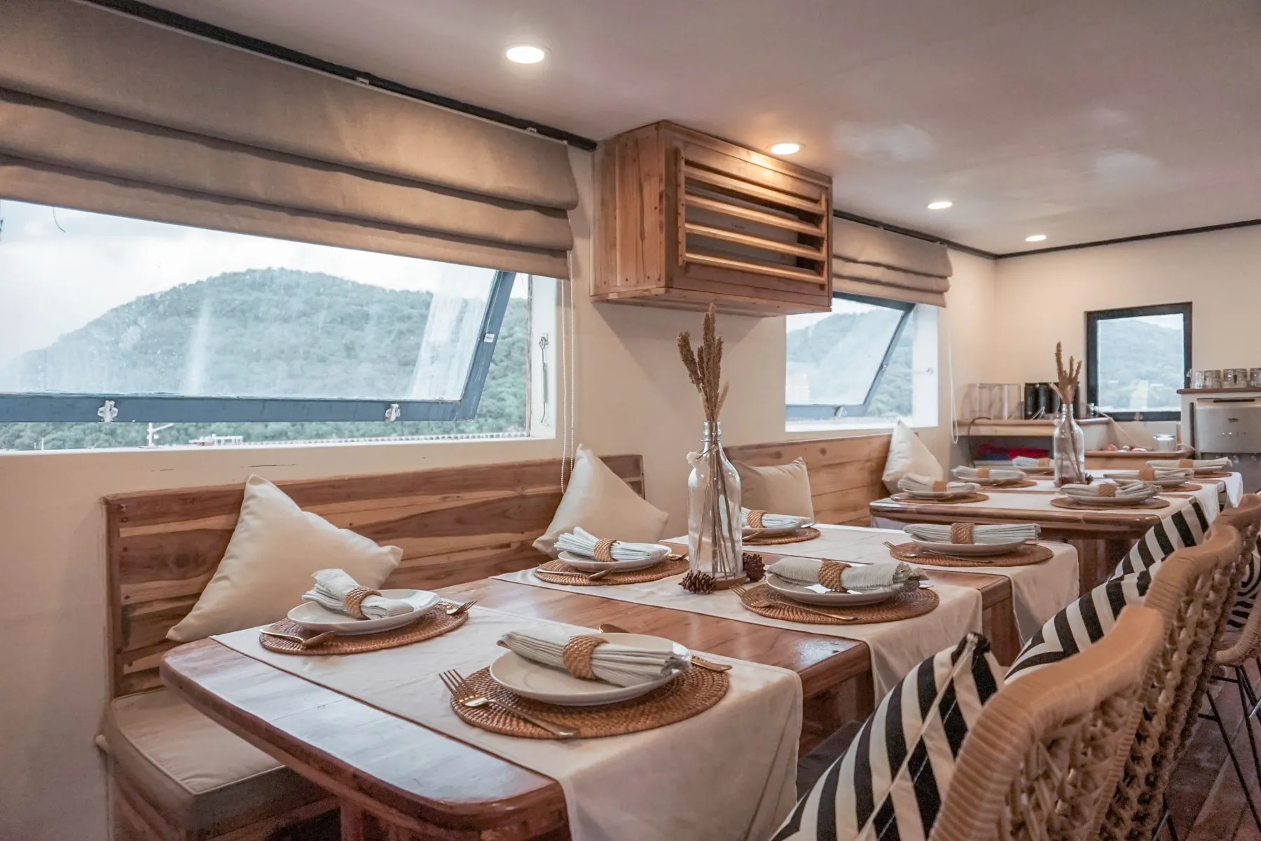 The Sea Familia I indoor dining room with laid tables and rattan chairs